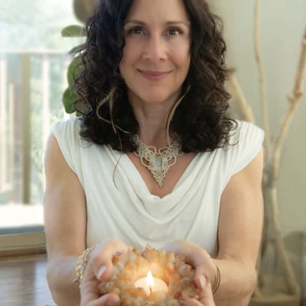 woman smiling a candle in her hands
