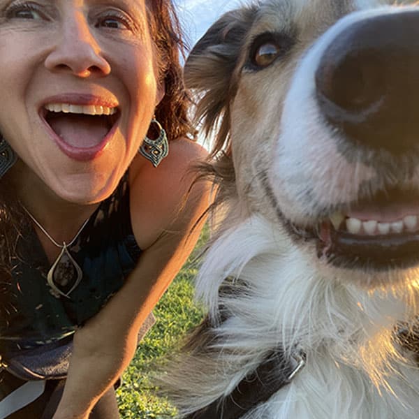 woman smiling with her dog
