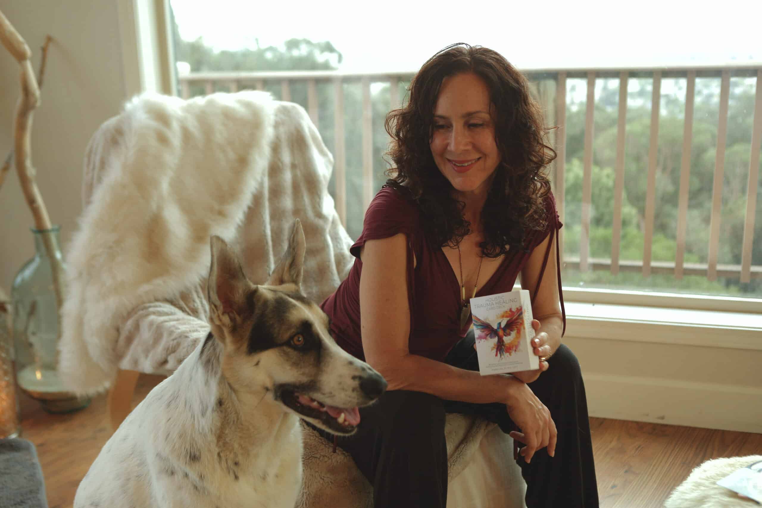 Angela Luna holding the free version of her deck card with her dog by her side<br />