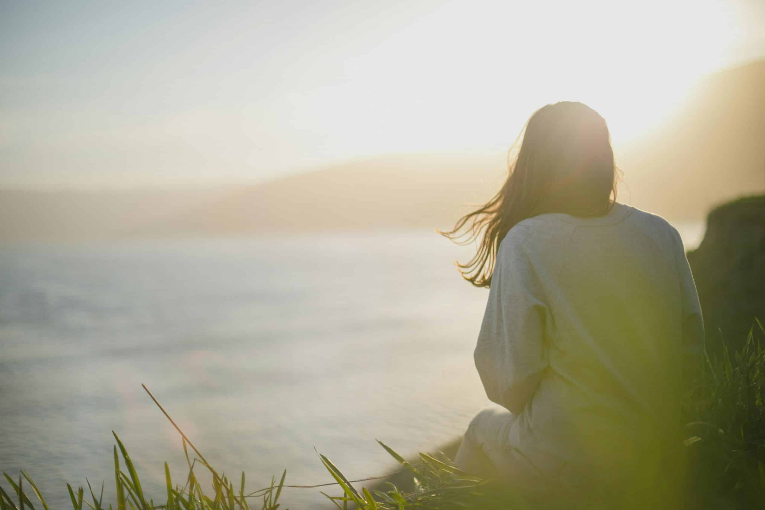 woman in nature, looking at the sea