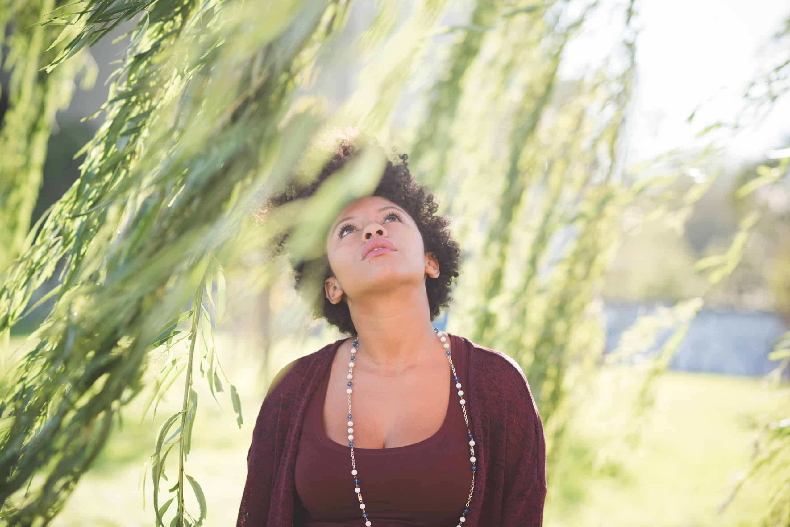 Young beautiful curly black hair woman outdoor in the city looking over- serene, attitude, emancipation concept -Calming the mind