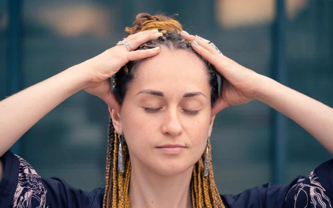 young woman holding her head